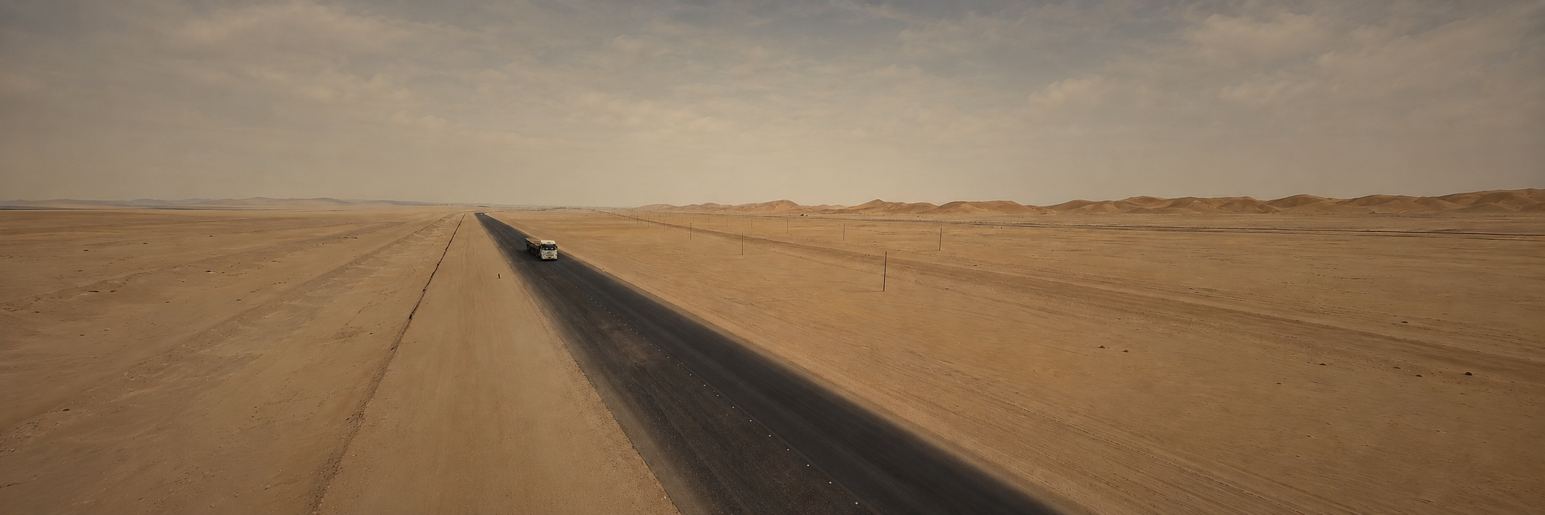 Full-bleed Namib road panorama extended from the real client road frame.